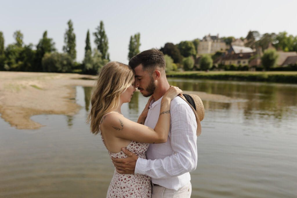 Couple enlacé avec tendresse sur la plage en milieu d'après-midi.