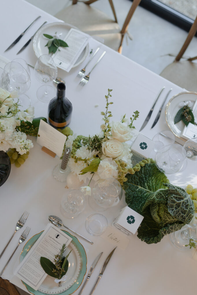 Centre de table avec raisins, oignons et choux pour un mariage style Bridgerton à Reims.